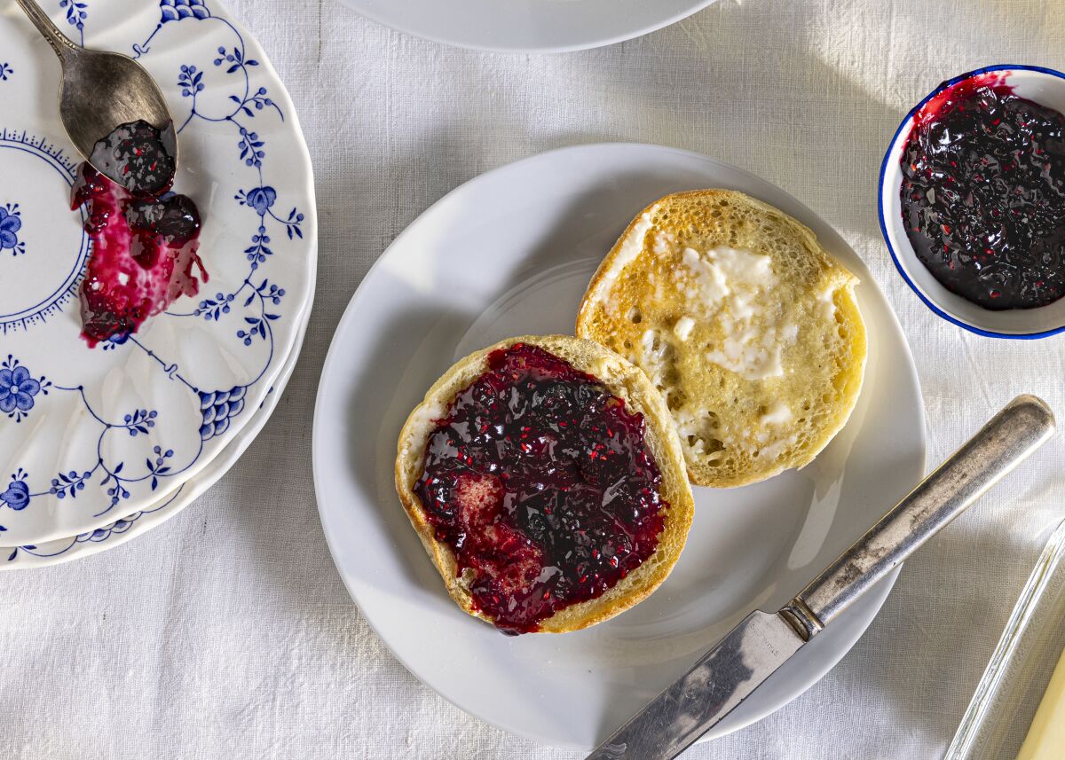 English muffins spread with butter and Summer Pudding Jam