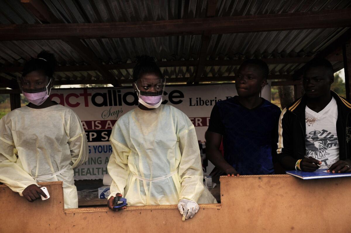 Health workers in Sierra Leone enforce a three-day lockdown to curb the spread of Ebola in March. A new analysis sheds light on the evolution of the current outbreak.