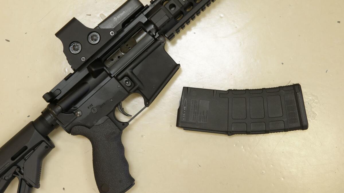 A custom-made semiautomatic hunting rifle with a high-capacity detachable magazine is displayed at TDS Guns in Rocklin, Calif., on Oct. 3, 2013