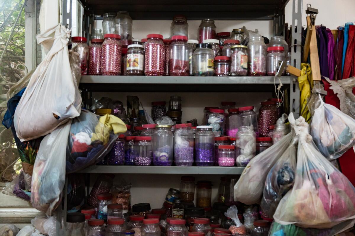 Beads are oganized by color on a workshop shelf. (Sima Diab / For The Times)