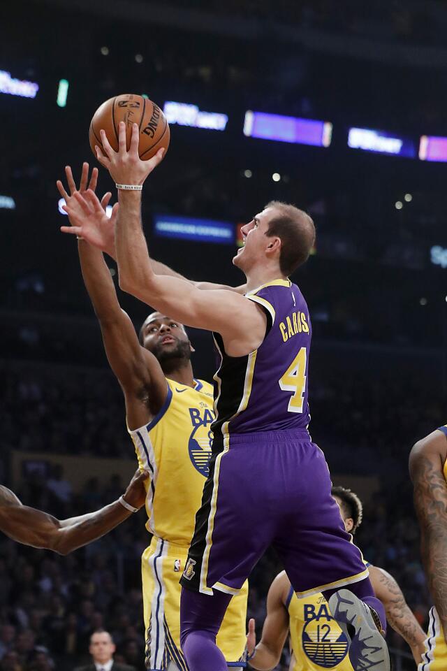 Lakers guard Alex Caruso shoots and scores over Warriors guard Alec Burks in the second quarter.