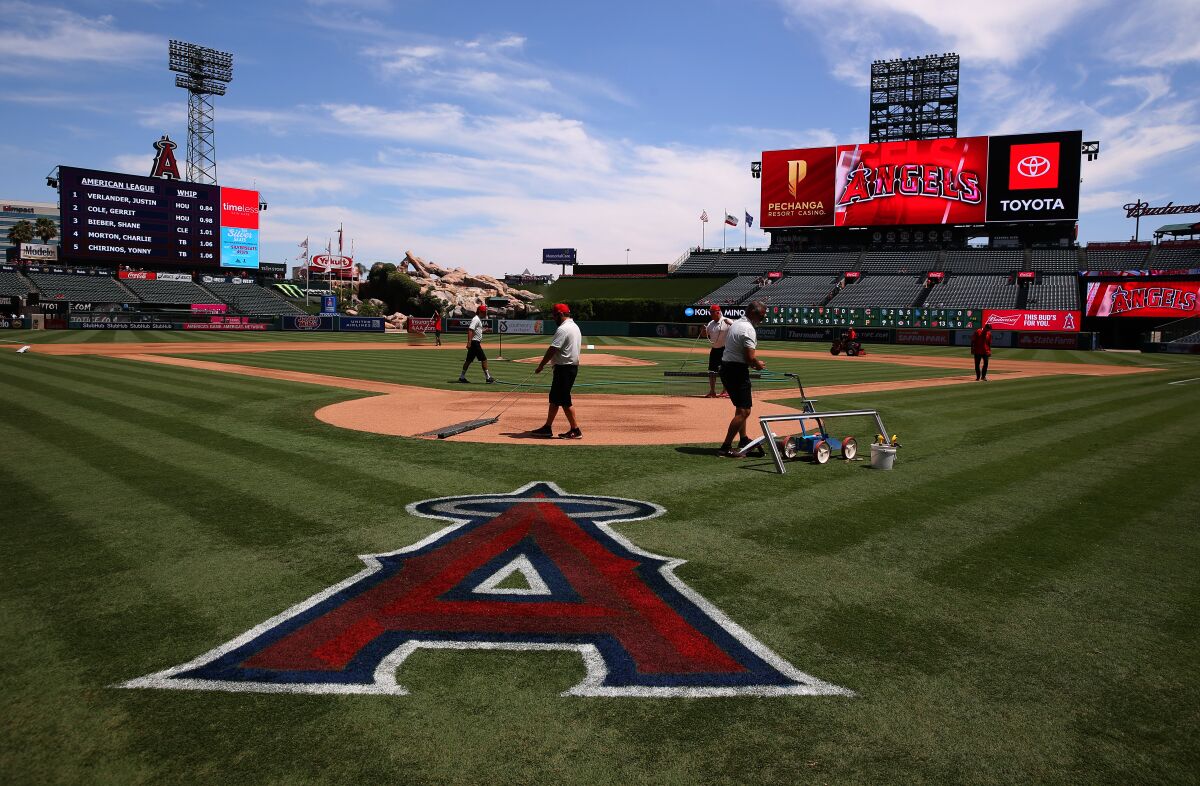 Grounds crews work on the field at Angel Stadium.