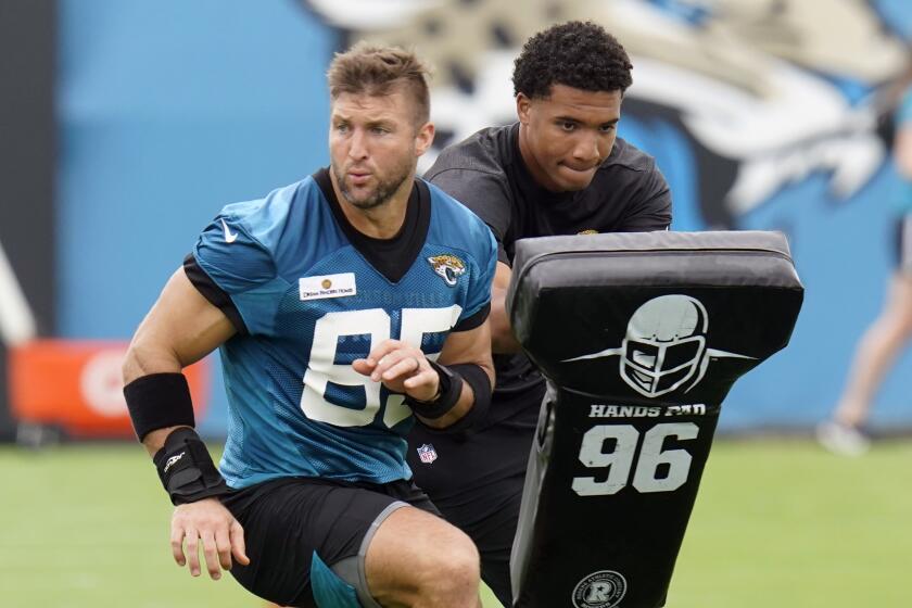 Jacksonville Jaguars tight end Tim Tebow performs a drill during an NFL football practice, Monday, June 14, 2021, in Jacksonville, Fla. (AP Photo/John Raoux)