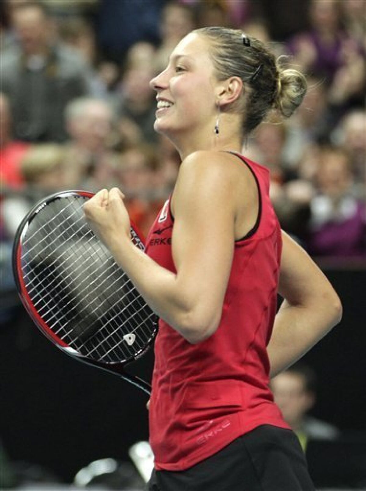 Belgium's Yanina Wickmayer celebrates defeating US player Bethanie Mattek-Sands during the World Group Fed Cup match in Antwerp, Belgium, Saturday, Feb. 5, 2011. (AP Photo/Yves Logghe)
