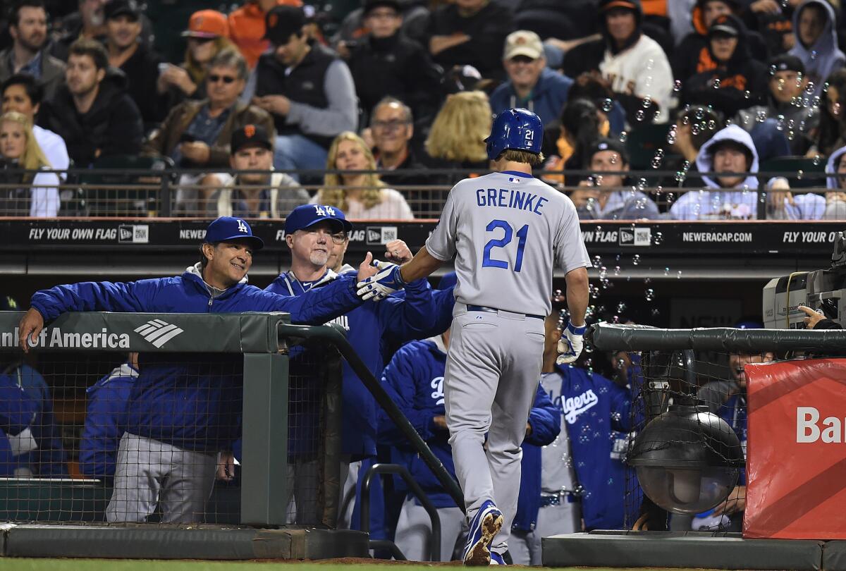 Dodgers pitcher Zack Greinke is congratulated by Manager Don Mattingly after hitting a two-run home run against the San Francisco Giants on Saturday night.