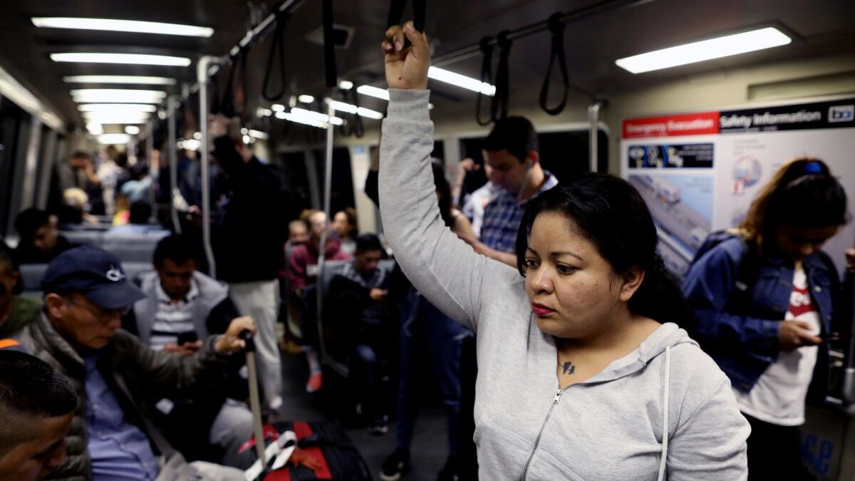 Veronica Aguilar, of El Salvador, fled her home country after receiving death threats from local gangs. Aguilar now lives with sponsor family Kent and Ann Moriarty in Pinole, Calif. Above she rides a BART train in Berkeley.