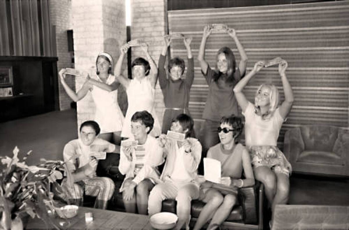 The "Original 9" women's tennis players pose with dollar bills Sept. 23, 1970, at the Houston Racquet Club. 