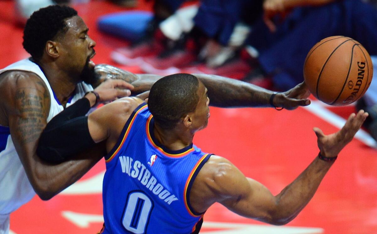 DeAndre Jordan and Oklahoma City's Russell Westbrook battle for a rebound during Thursday's game at Staples Center. Westbrook suffered a broken hand in the Thunder's loss to the Clippers, 93-90.