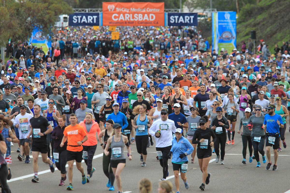Waves of runners start the Carlsbad Half Marathon Sunday.