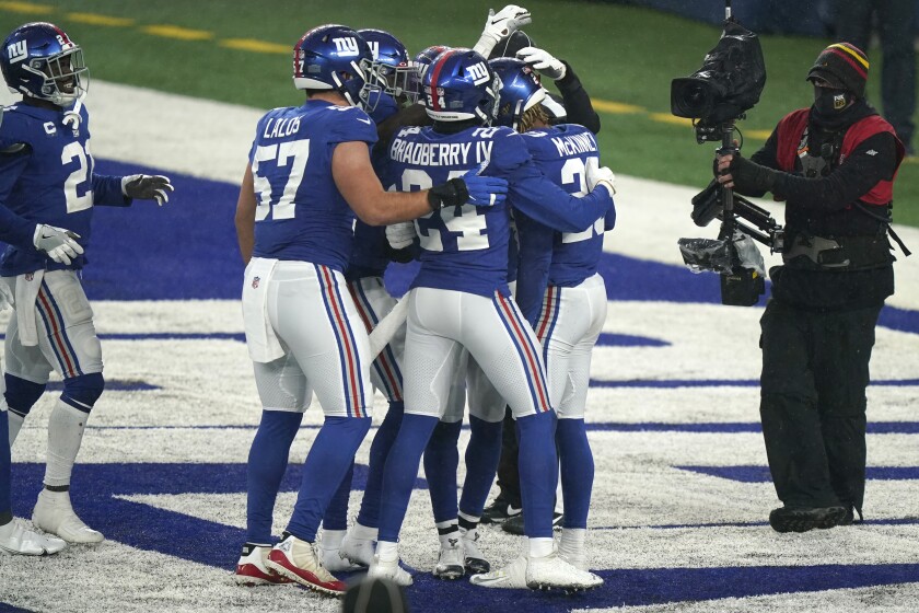 New York Giants' Xavier McKinney, right, celebrates his interception in the end zone during the second half of an NFL football game against the Dallas Cowboys, Sunday, Jan. 3, 2021, in East Rutherford, N.J. (AP Photo/Corey Sipkin)