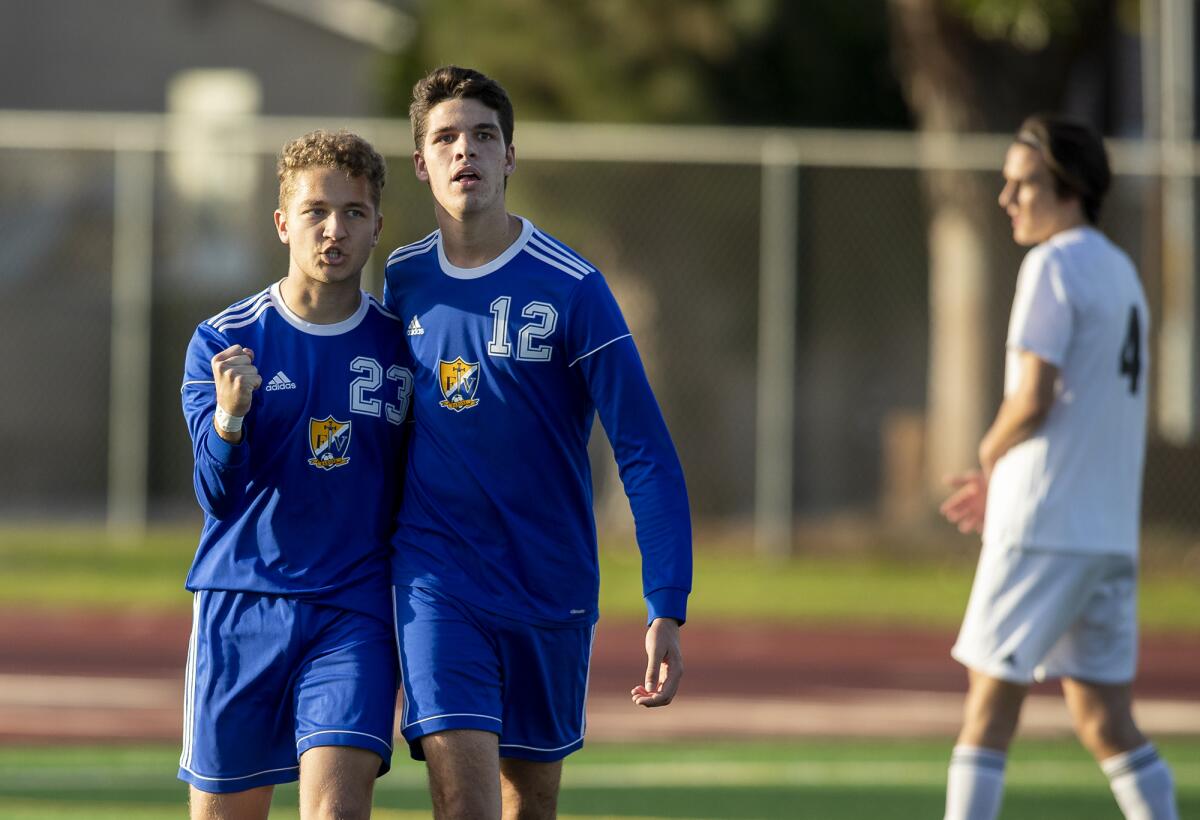 Fountain Valley's Sebastian Rus, left, and Austin Pennella celebrate after Rus scored a goal against Huntington Beach in the 66th minute of a Wave League match on Wednesday.