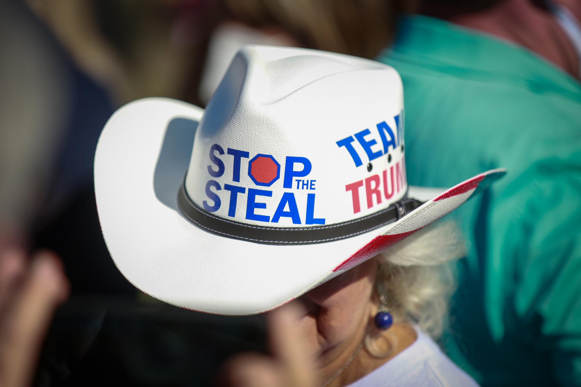 A woman in a cowboy hat with the message "Stop the steal."