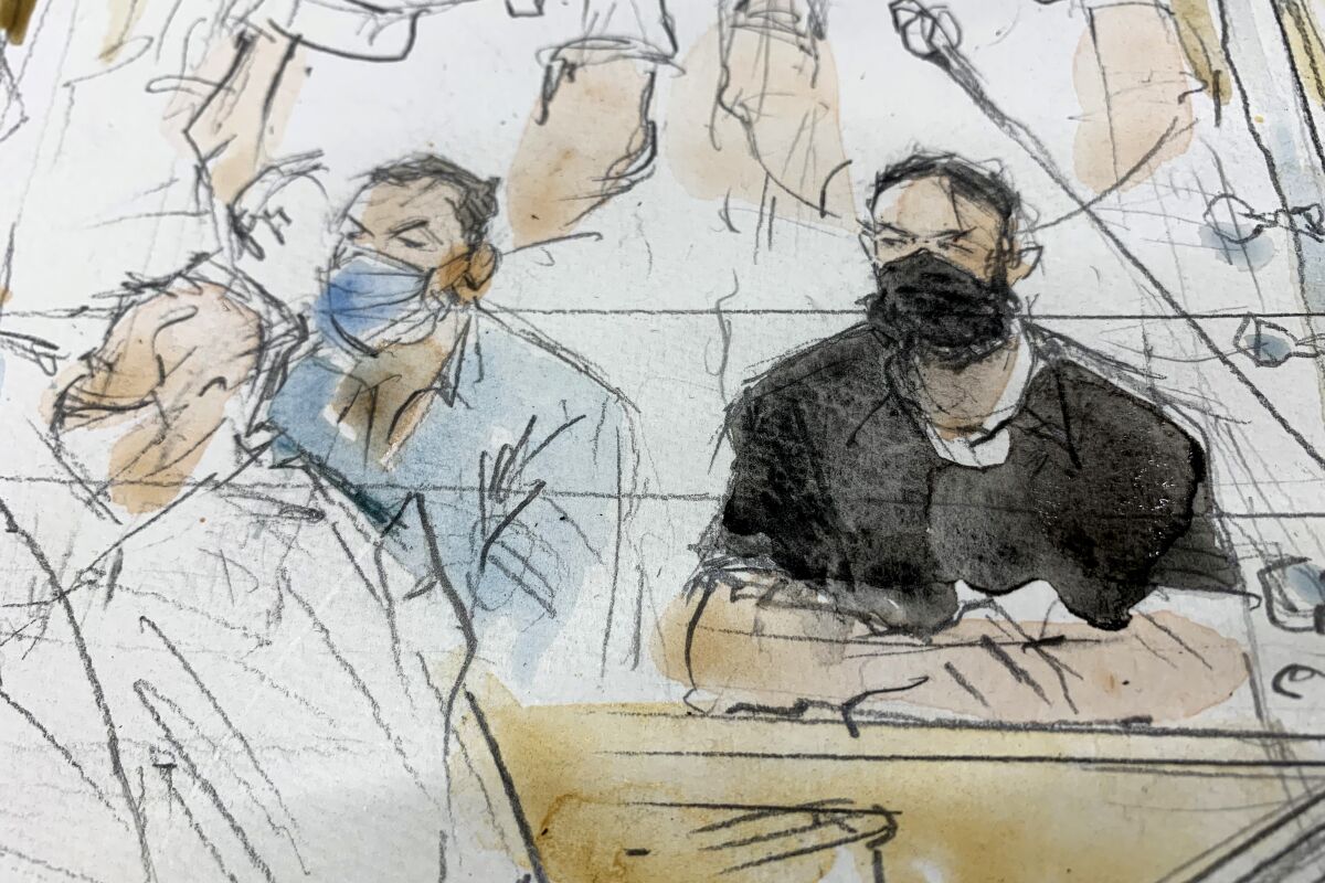 FILE - Sept.8, 2021 file sketch shows key defendant Salah Abdeslam, right, and Mohammed Abrini in the special courtroom built for the 2015 attacks trial. The key defendant in the 2015 Paris attacks trial said Wednesday that the Islamic State network which struck the city was attacking France, and that the deaths of 130 people was "nothing personal." Wearing all black and declining to remove his black mask, Salah Abdeslam was the last of the 14 defendants present in the custom-built courtroom to speak. (Noelle Herrenschmidt via AP, File)