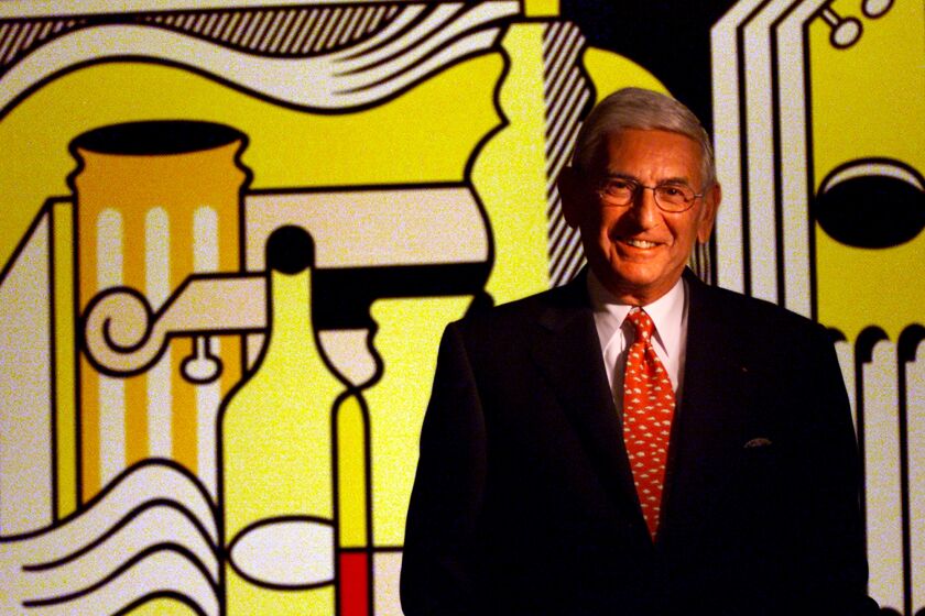 Eli Broad in front of Roy Lichtenstein's painting "Purist Still Life." 