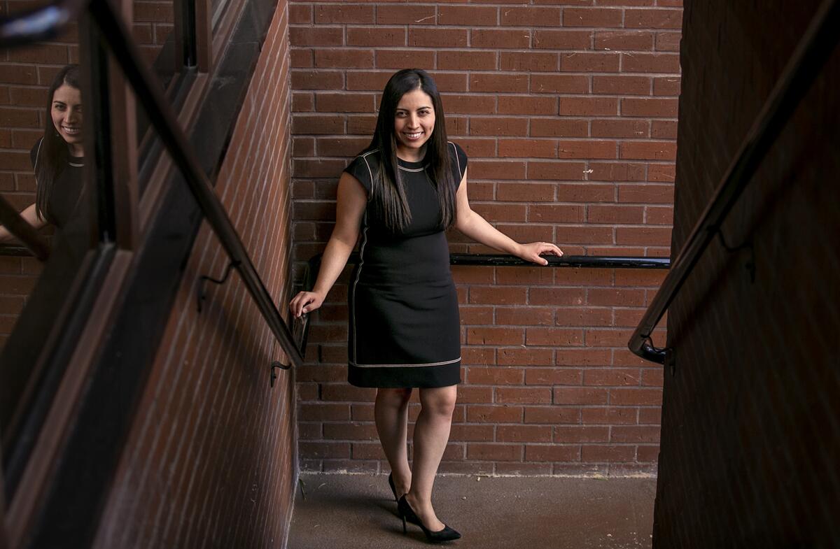 Daisy Esparza stands in a stairwell.