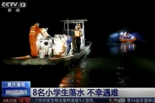 An image taken from China's CCTV video shows rescue workers searching along a river in China's Chongqing province.