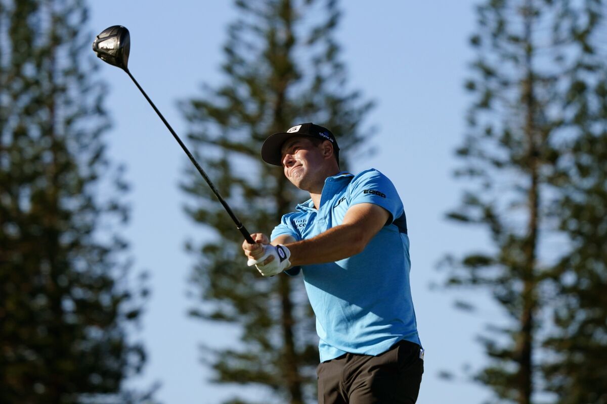 Viktor Hovland, of Norway, hits from the13th tee during the Tournament of Champions pro-am team play golf event, Wednesday, Jan. 5, 2022, , at Kapalua Plantation Course in Kapalua, Hawaii. (AP Photo/Matt York)
