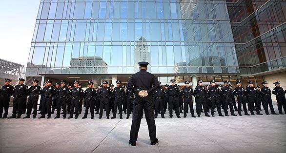 LAPD Det. Salaam Abdul-Rahman faces the officers of the Robbery-Homicide Division standing at ease in preparation for Chief William Bratton's command inspection of the Robbery-Homicide Division at the new Los Angeles Police Administration Building in downtown Los Angeles on Friday morning.