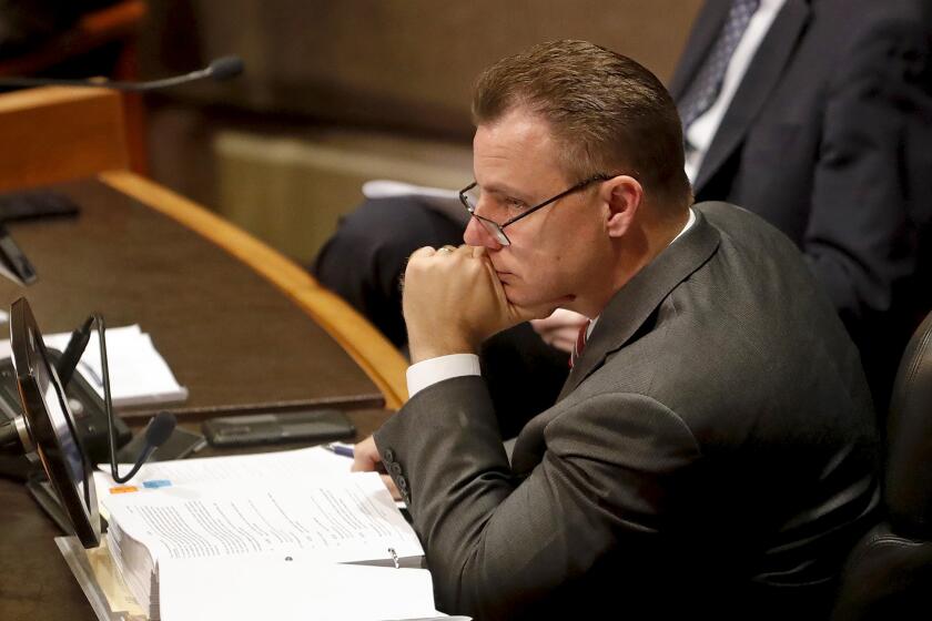 City Atty. Michael Gates listens to public comments during Huntington Beach City Council meeting in June 2022.