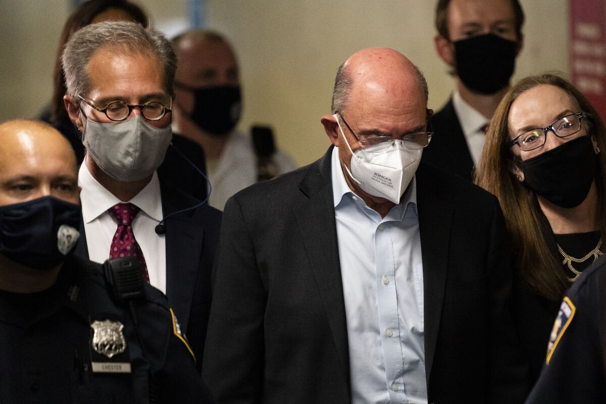 FILE - In this Thursday, July 1, 2021, file photo, Allen Weisselberg, center, departs Manhattan criminal court, in New York. The move by Donald Trump's company to strip its top finance chief, Weisselberg, from several leadership positions less than two weeks after his criminal indictment suggests it is facing a tricky, new business environment as it seeks to reassure lenders and other business partners. (AP Photo/John Minchillo, File)