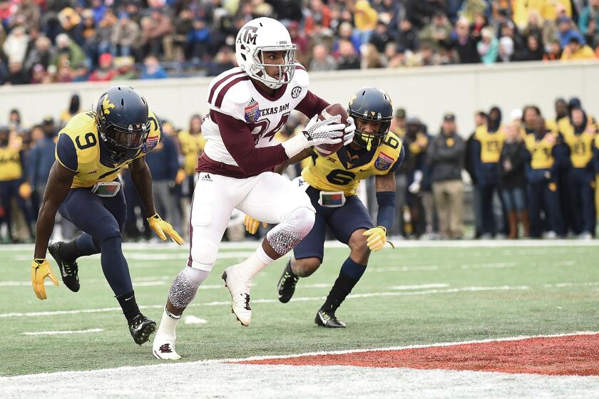 Texas A&M receiver Malcome Kennedy scores a touchdown against West Virginia during the second quarter of the Liberty Bowl in Memphis.
