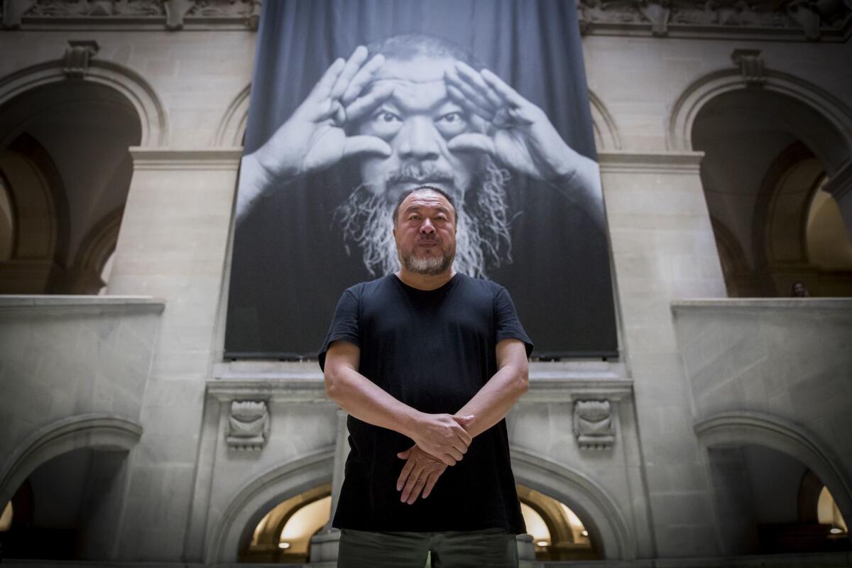 Ai Weiwei at the entrance to his exhibition "Ai Weiwei. D'ailleurs c'est toujours les autres" at the Musee Cantonal des Beaux-Arts in Lausanne, Switzerland.