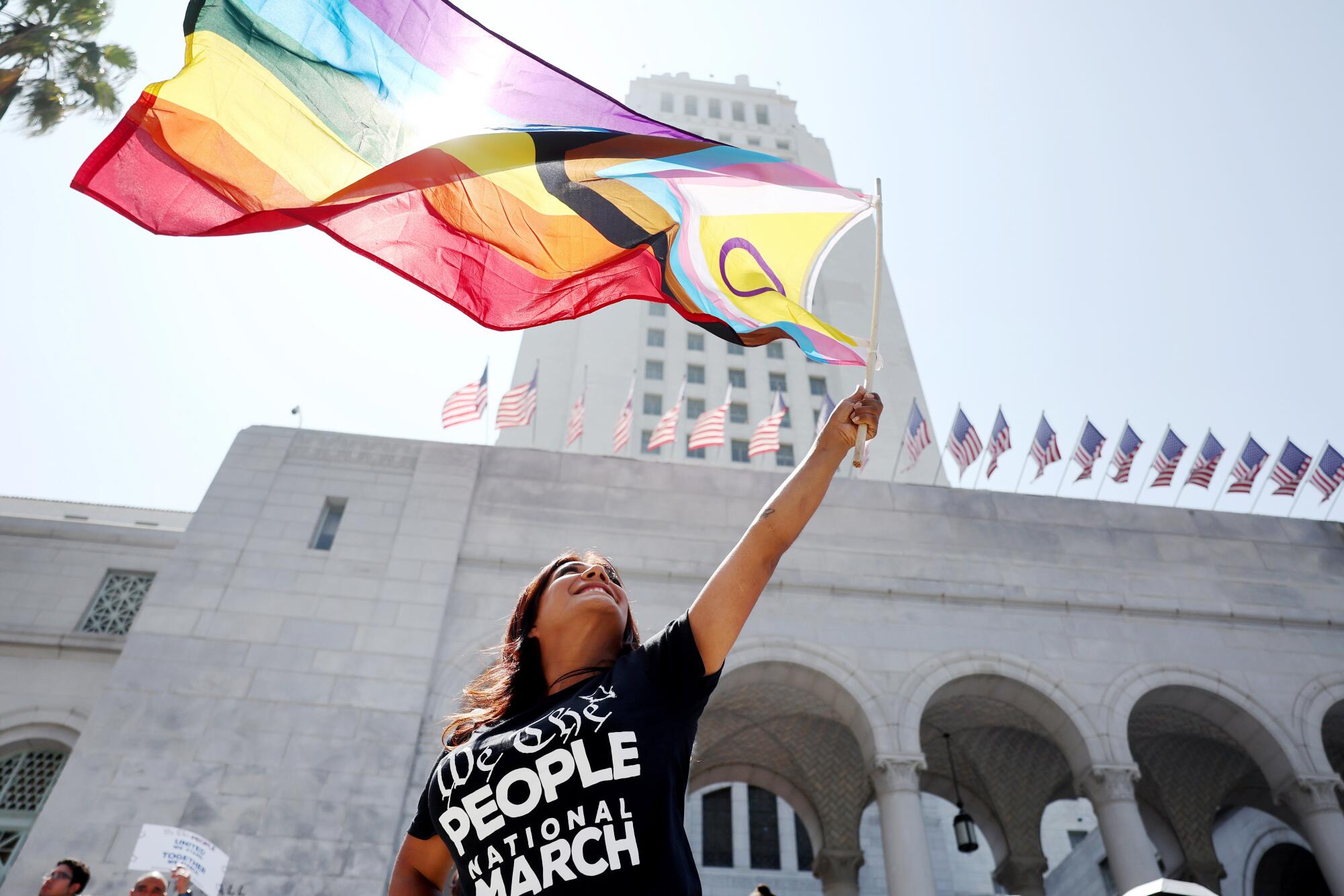 A demonstrator waves the intersex-inclusive Pride flag during the We the People March on July 2, 2023, in Los Angeles.