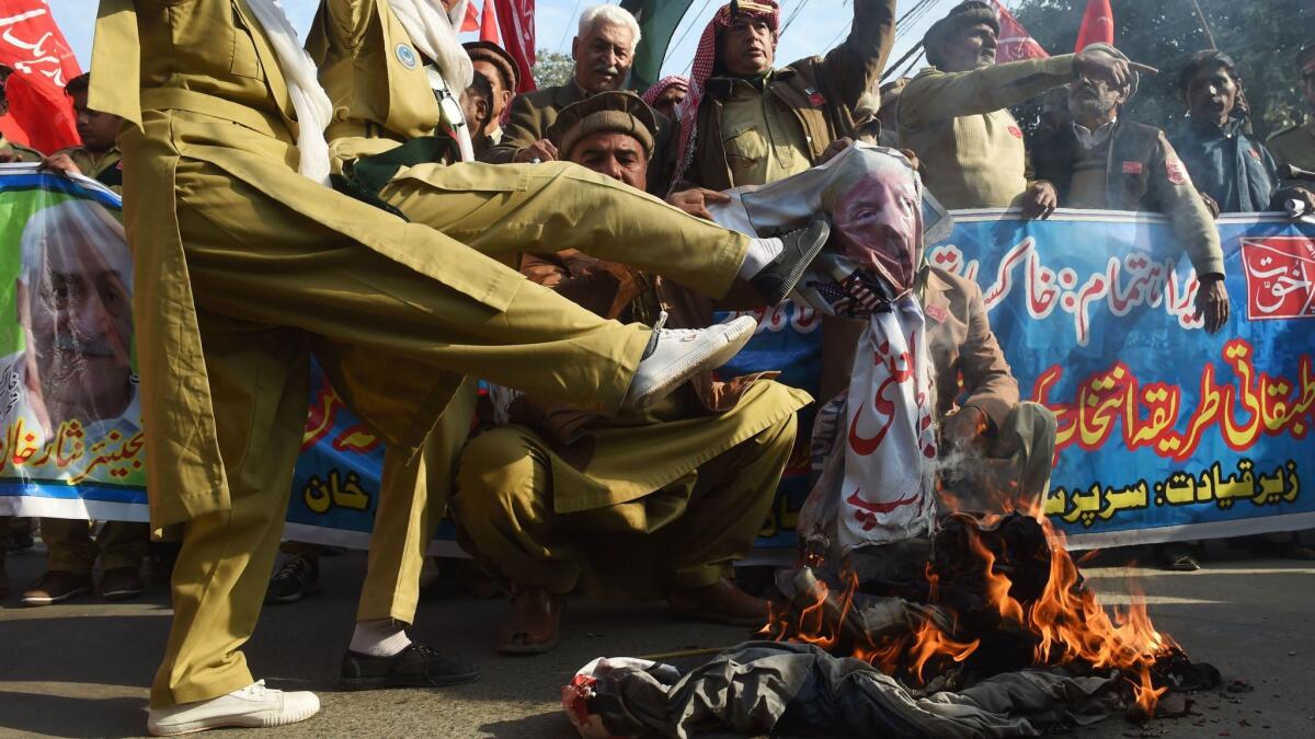 Pakistani demonstrators burn an effigy of President Trump during an anti-US protest in Lahore on Jan. 10.