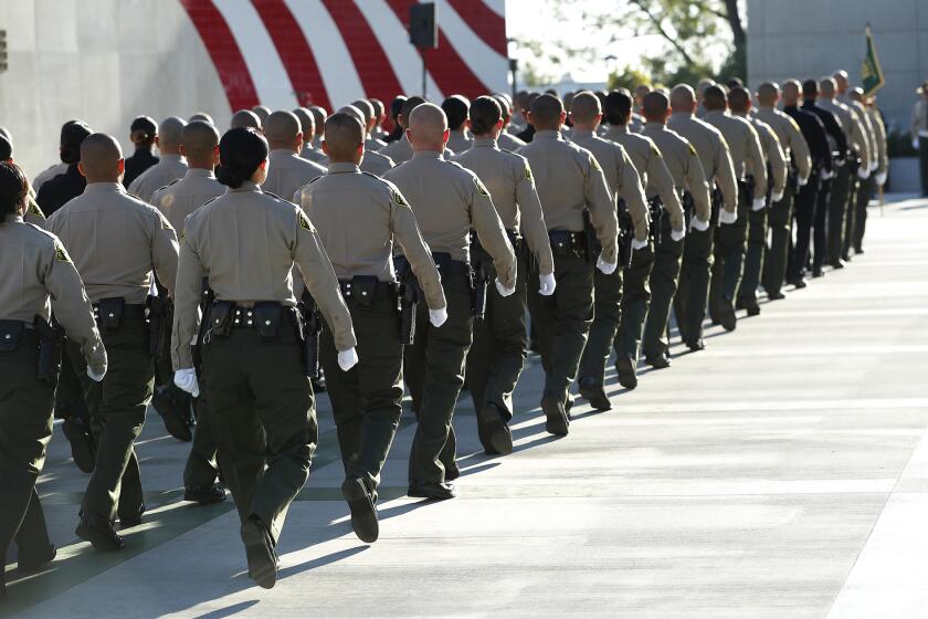 Los Angeles County Sheriffs deputies walk in formation during the start of their graduation ceremony at the Biscailuz Training Center of the Los Angeles County Sheriff's Dept. in East Los Angeles on Oct. 27, 2017.