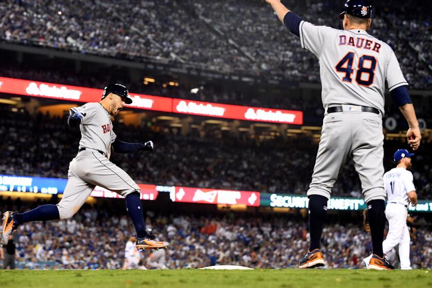 Astros center fielder George Springer celebrates his two-run home run against the Dodgers in the 11th inning of Game 2.