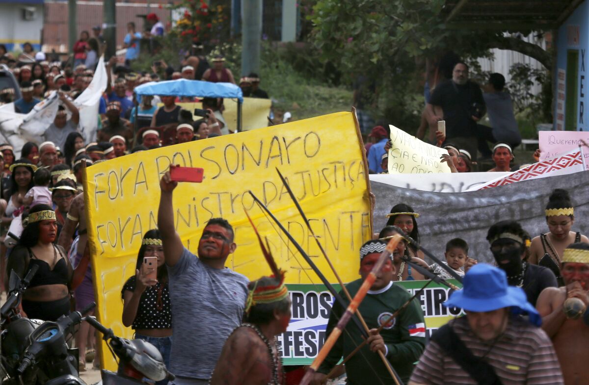 Indigenous people march during a protest against the disappearance of Indigenous expert Bruno Pereira and freelance British journalist Dom Phillips, in the city of Atalaia do Norte, Vale do Javari, state of Amazonas, Brazil, Monday, June 13, 2022. Brazilian police are still searching for Pereira and Phillips, who went missing in a remote area of Brazil's Amazon a week ago. (AP Photo/Edmar Barros)