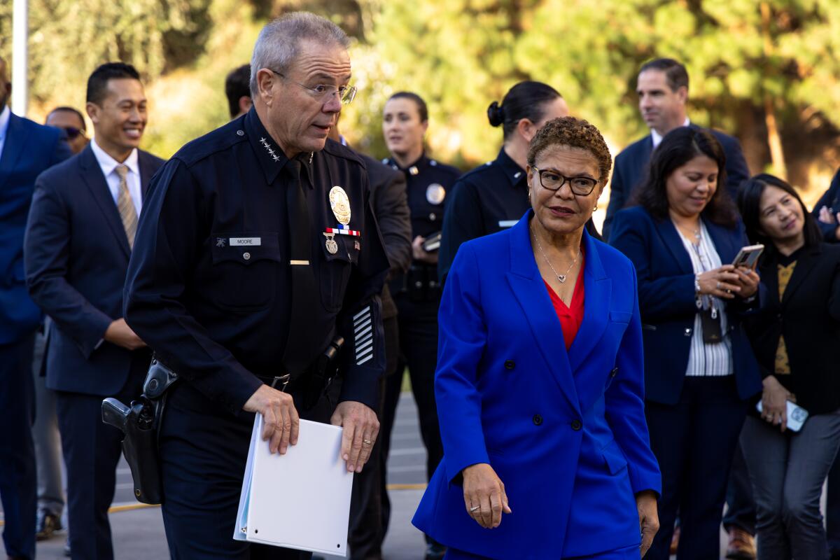 LAPD Chief Michel Moore, left, accompanies Mayor Karen Bass at LAPD Police Academy on Dec. 7 in Los Angeles.
