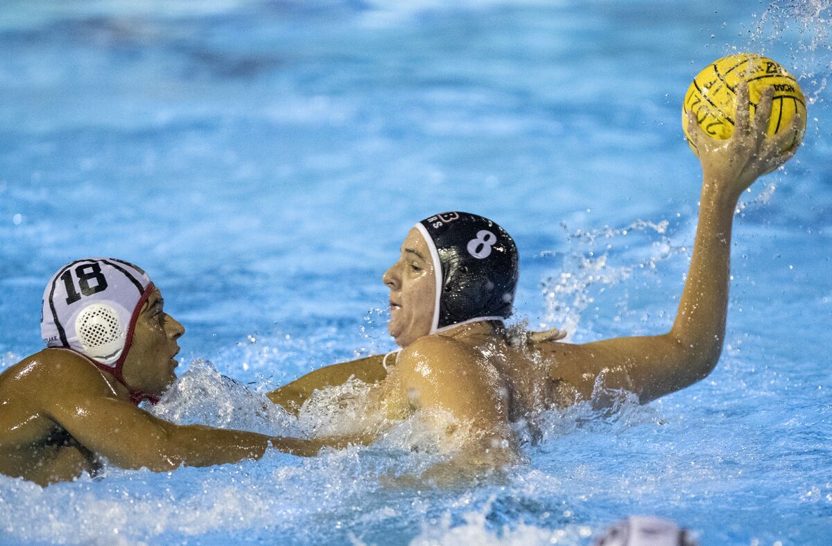 Huntington Beach's James Rozolis-Hill loads up to take a shot under pressure from a Harvard-Westlake defender on Nov. 10.