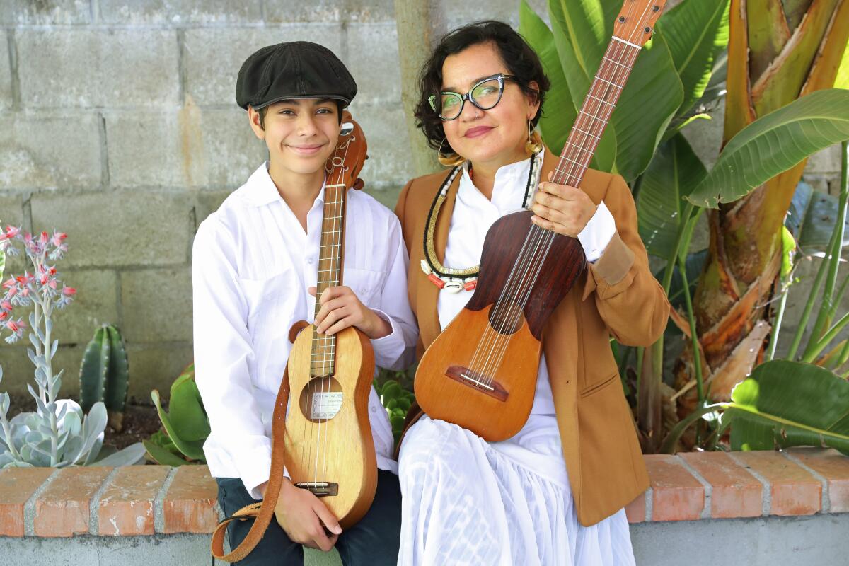 Martha Gonzalezr of music group Quetzal and her son Sandino Gonzalez-Flores, 15, at their home.