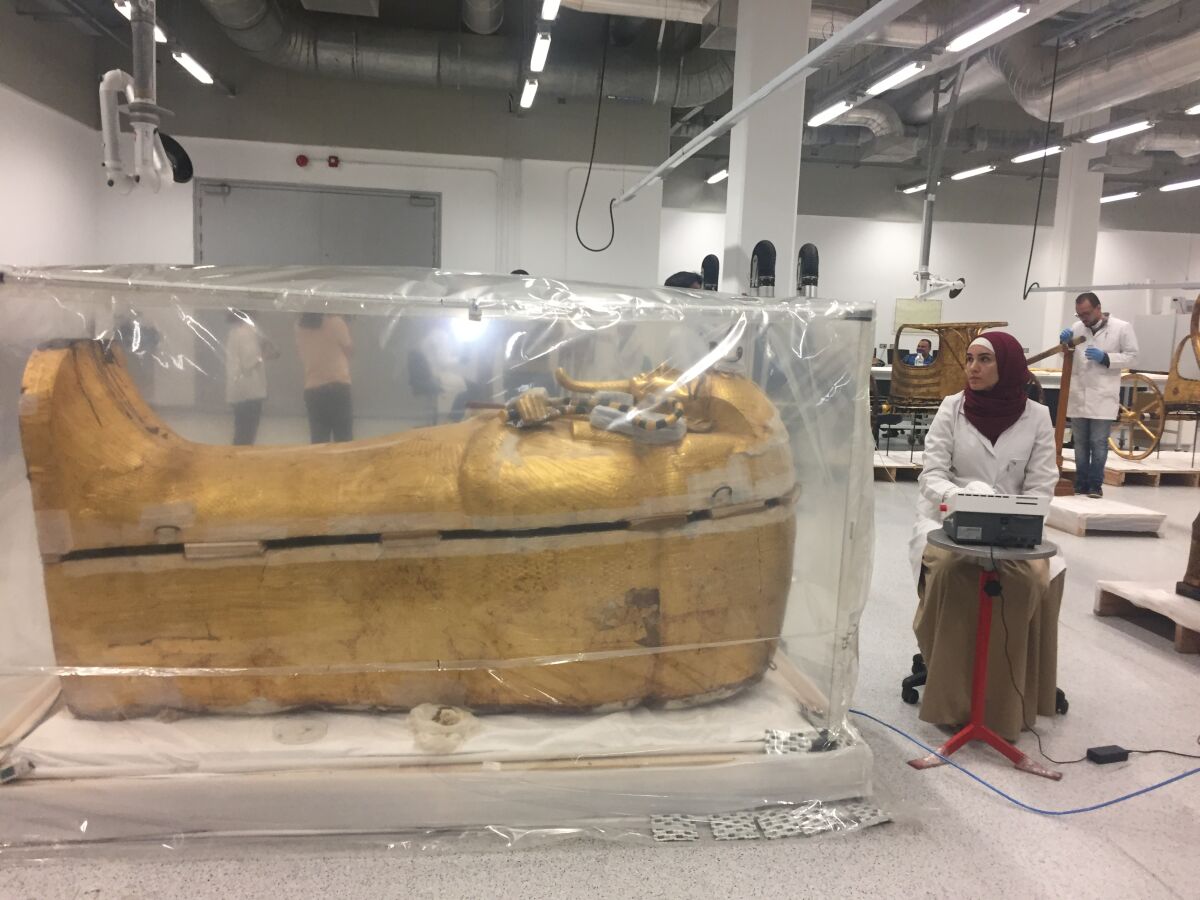 The coffin inside a plastic incubator in one of the laboratories of the Grand Egyptian Museum