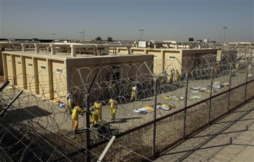 FILE - In this Nov. 10, 2008 file photo, detainees are seen outside their cell block at the U.S. detention facility at Camp Cropper in Baghdad, Iraq. Four prisoners with links to al-Qaida have escaped from the U.S.-controlled part of a maximum-security prison in Baghdad, U.S. and Iraqi officials said Thursday, Sept. 9, 2010. (AP Photo/Maya Alleruzzo, File)
