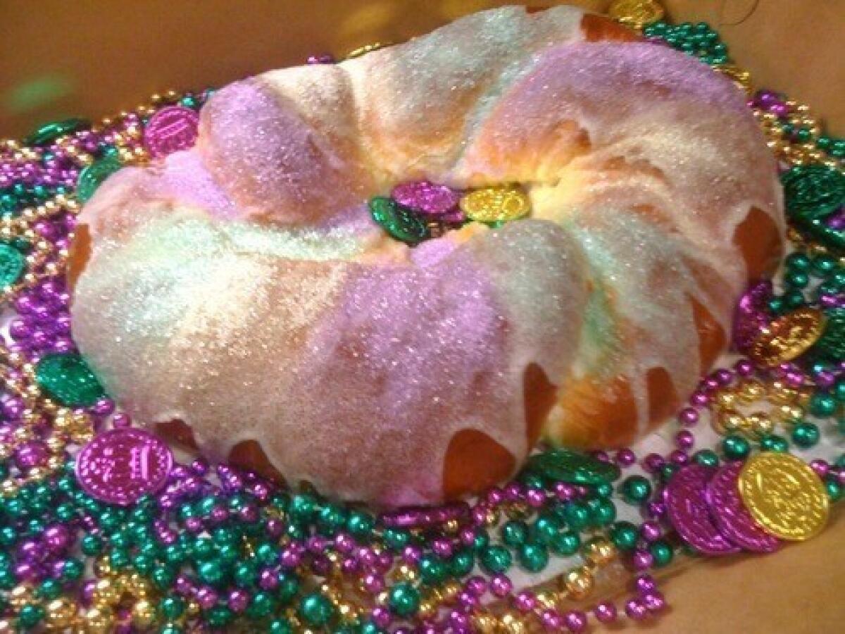 This Mardi Gras king cake has apple and cream cheese fillings.