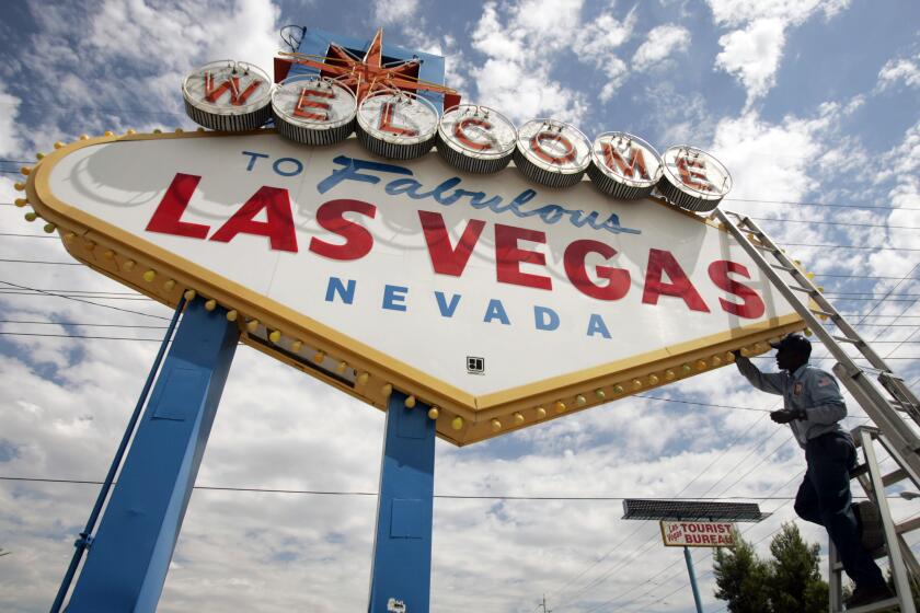 FILE - In this July 28, 2005, file photo, an electric company worker changing ballasts and lamps on the "Welcome to Las Vegas," sign in Las Vegas. Many players on the Vegas Golden Knights didn’t know what to expect of their new city. They have found it is much more than bright lights, casinos and shows on the Strip. The Vegas hosts Game 1 of the Stanley Cup Final on Monday night, May 28, 2018, against the Washington Capitals. (AP Photo/Joe Cavaretta, File)