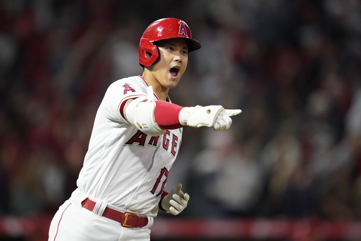 Angels designated hitter Shohei Ohtani reacts as he runs the bases after hitting a grand slam.