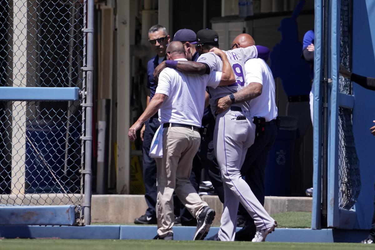 Jurickson Profar of the Colorado Rockies walks off the field