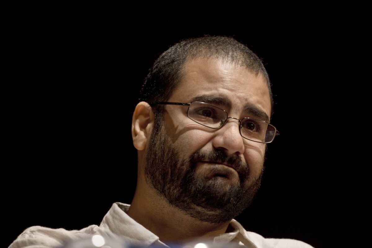 FILE - In this Sept. 22, 2014, file photo, Egypt's leading pro-democracy activist Alaa Abdel-Fattah takes a moment as he speaks about his late father Ahmed Seif, one of Egypt's most respected human rights lawyers, during a conference held at the American University in Cairo, Egypt. The trial of Egyptian activists Alaa Abdel-Fattah, Mohamed Ibrahim and Yahia Hussein Abdel-Hadi and lawyer Mohammed el-Baker, who have been imprisoned for over two years, began Monday, Oct. 18, 2021, Khalid Ali, their lawyers said. The four face charges ranging from disseminating false news and misuse of social media platforms to joining a terrorist group, a reference to the Muslim Brotherhood, which Egypt designated as a terrorist group in 2013. (AP Photo/Nariman El-Mofty, File)