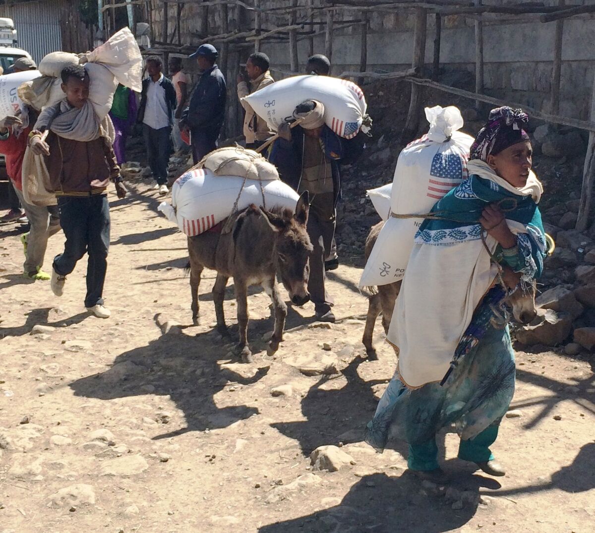 Families begin their journey home with U.S. food aid from a distribution site in Denkena Kebele, Ethiopia, on Dec. 14, 2015.