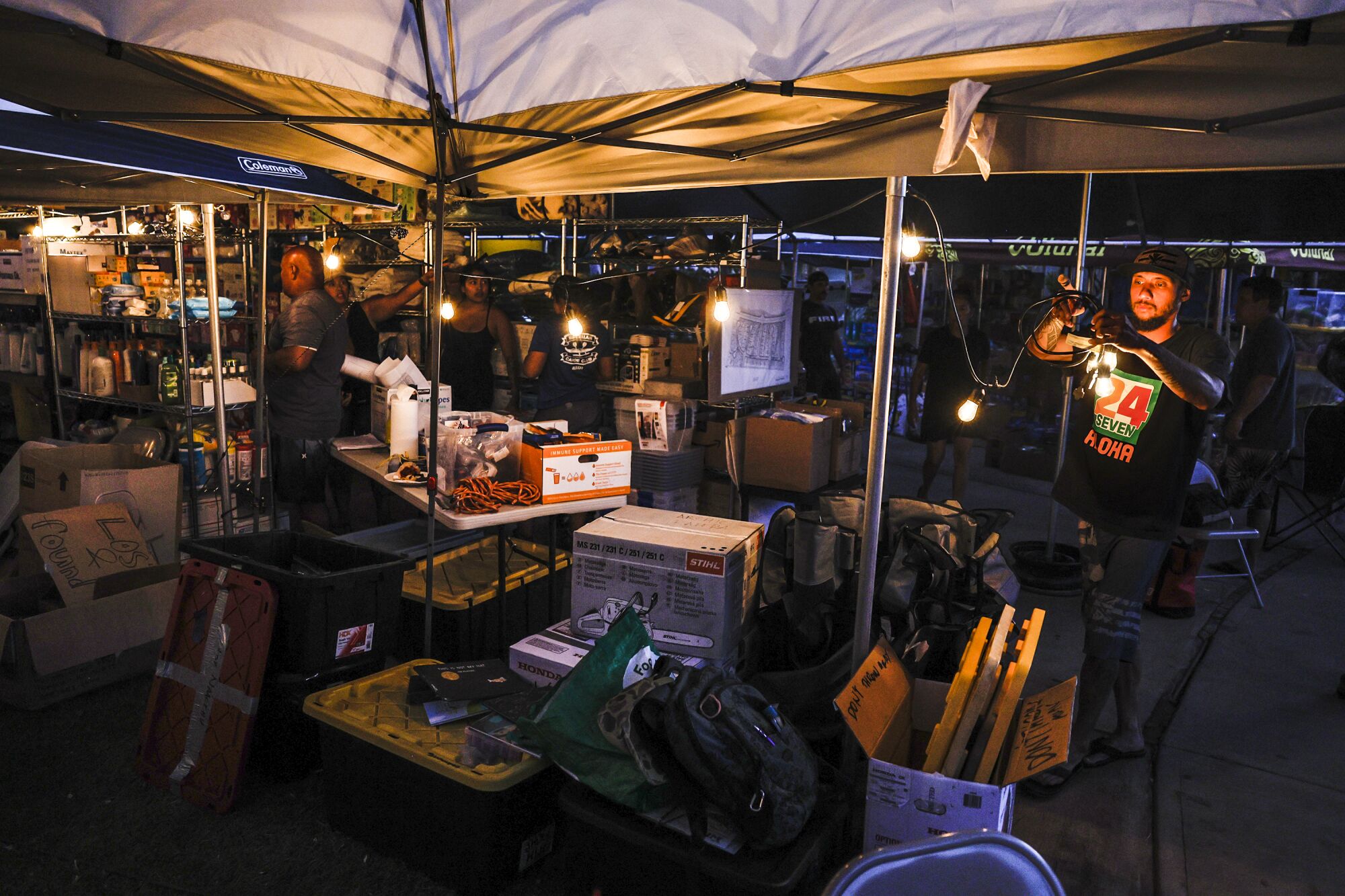 A tent on the frontyard of Archie Kalepa's home serves as a distribution center of food and supplies 