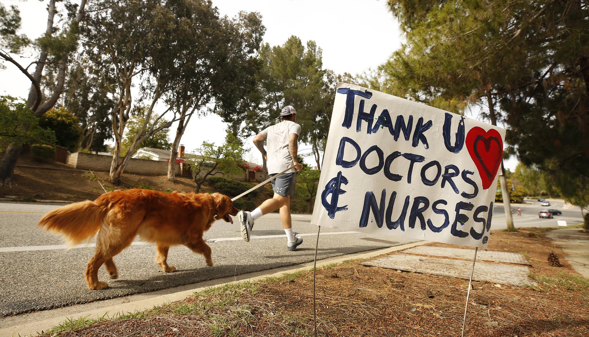 A jogger and his dog on the route to Los Robles Hospital & Medical Center in Thousand Oaks.