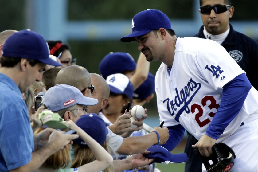 Dodgers first baseman Adrian Gonzalez signs autographs at Dodger Stadium.