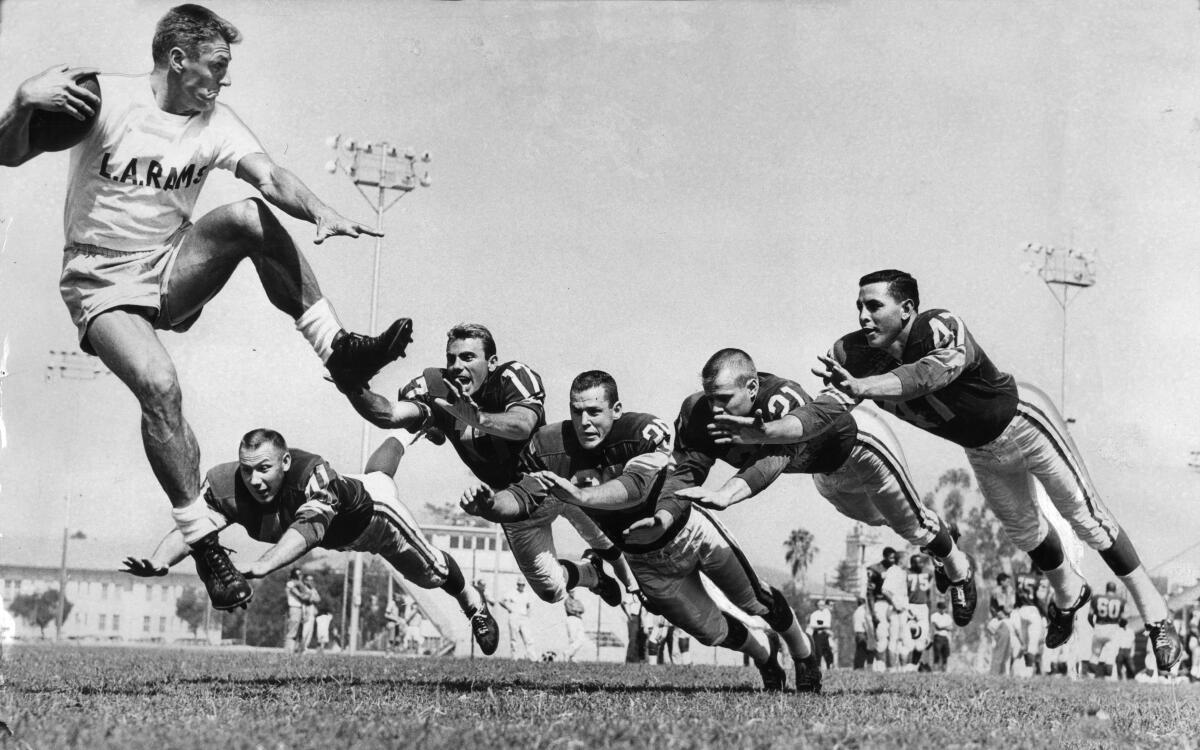 Rams general manager Elroy Hirsch dazzles his defensive backs during training camp at Redlands University on July 20, 1961.