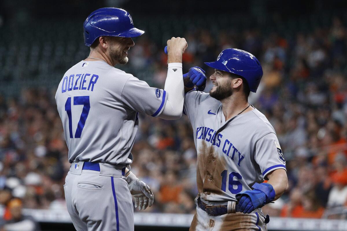 Kansas City Royals' Hunter Dozier celebrates with Andrew Benintendi after hitting a two-run home run off Houston Astros starting pitcher Cristian Javier during the first inning of a baseball game Wednesday, July 6, 2022, in Houston. (AP Photo/Kevin M. Cox)