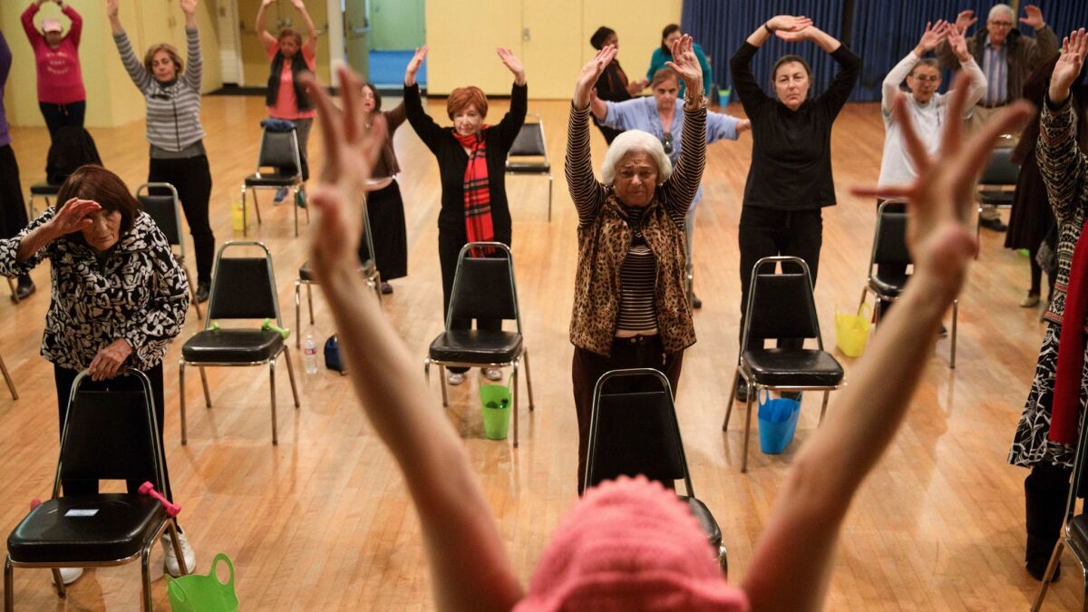 Instructor Jann Karam, wearing a pink "pussy hat," leads a senior fun fitness class at the Westside Jewish Community Center in Los Angeles.