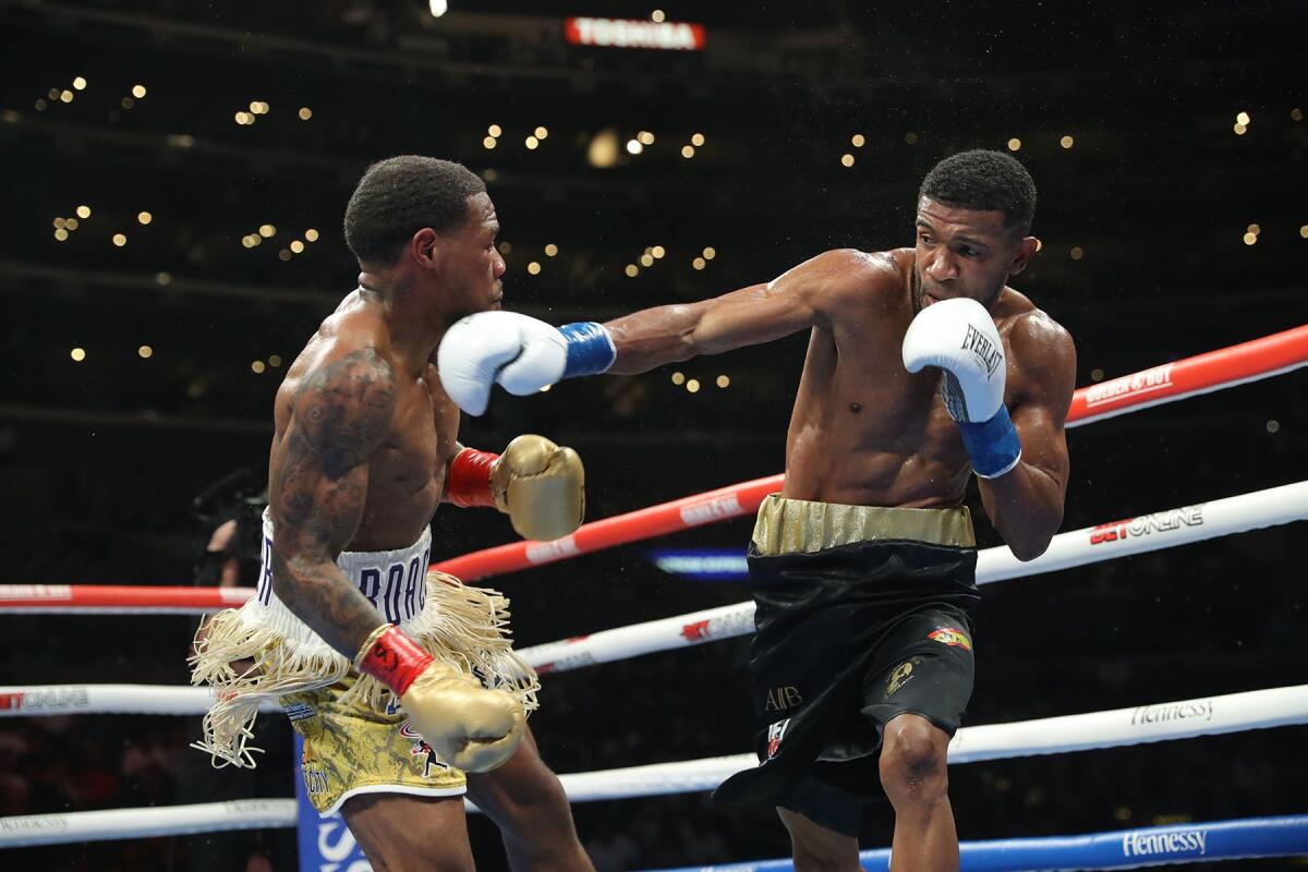 Lamont Roach, left, ducks away from a punch thrown by Angel Rodriguez during their fight on Saturday night