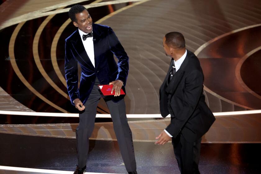 HOLLYWOOD, CA - March 27, 2022. Chris Rock and Will Smith onstage during the show at the 94th Academy Awards at the Dolby Theatre at Ovation Hollywood on Sunday, March 27, 2022. (Myung Chun / Los Angeles Times)